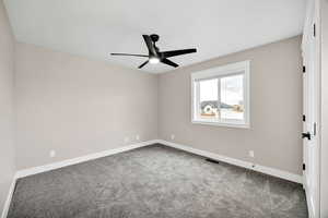 Spare room with carpet flooring and a ceiling fan