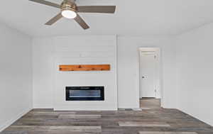 Unfurnished living room featuring a fireplace and wood finished floors
