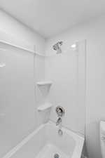 Bathroom with shower / bath combination and toilet