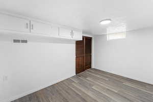 Basement featuring baseboards and light wood-style flooring