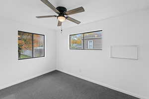 Unfurnished room with carpet, a textured ceiling, and a ceiling fan