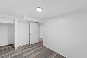 Unfurnished bedroom featuring wood finished floors and a closet