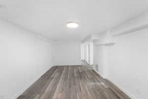 Empty room with wood finished floors and baseboards