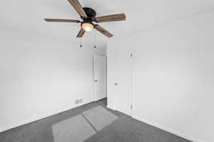Spare room with carpet flooring and ceiling fan