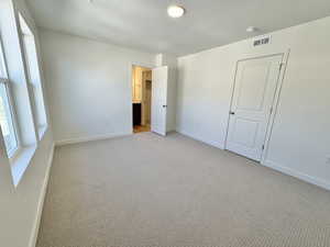 Unfurnished bedroom with carpet floors and a textured ceiling