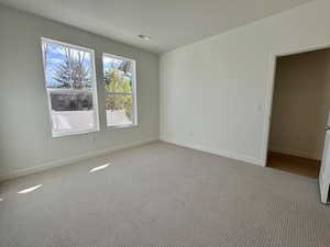 Spare room with carpet and a textured ceiling