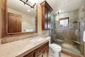 Bathroom featuring vanity and a shower stall