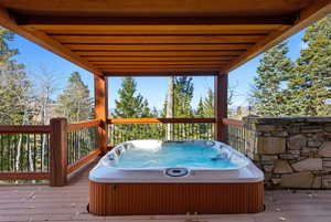 Deck with a hot tub and grilling area