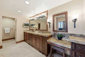 Bathroom featuring double vanity, a chandelier, recessed lighting, and light tile patterned floors