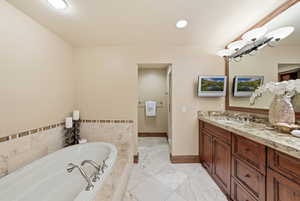 Full bathroom with a bath, vanity, recessed lighting, and light tile patterned flooring