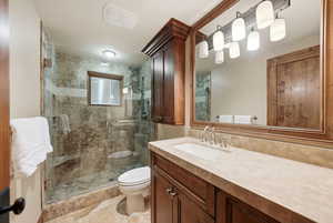 Bathroom featuring vanity, a stall shower, and light tile patterned floors