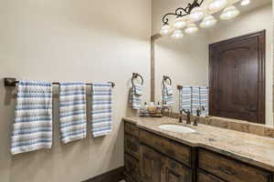 Bathroom featuring vanity and baseboards