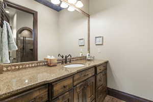 Full bathroom featuring a shower stall and vanity