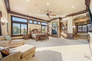 Bedroom with a glass covered fireplace, ornamental molding, carpet, and recessed lighting