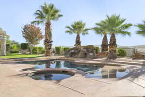 View of pool with a pool with connected hot tub