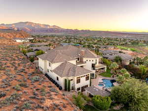 Aerial perspective of suburban area with a pool and mountains