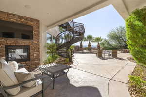 View of patio / terrace with an outdoor stone fireplace and stairway