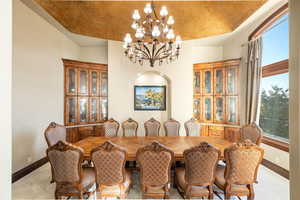 Dining area with a chandelier and light colored carpet