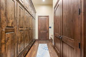 Doorway featuring hardwood / wood-style floors and baseboards