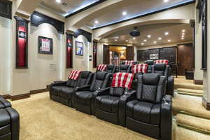 Home theater room with light carpet and recessed lighting