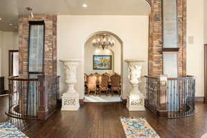 Hallway featuring a chandelier, an upstairs landing, and hardwood / wood-style flooring
