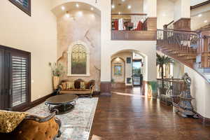 Community lobby featuring stairway and a towering ceiling