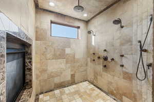 Bathroom with tiled shower and recessed lighting