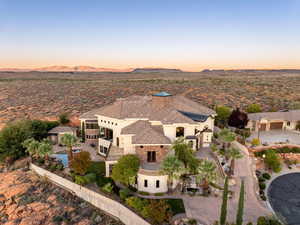 View of subject property with a mountain backdrop and a desert landscape