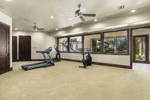 Exercise room with recessed lighting and a ceiling fan