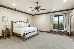 Bedroom with light colored carpet, crown molding, a ceiling fan, and recessed lighting