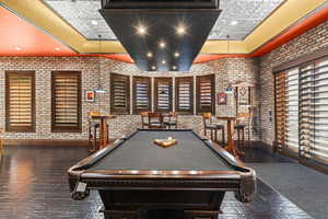 Playroom with billiards, recessed lighting, and brick wall