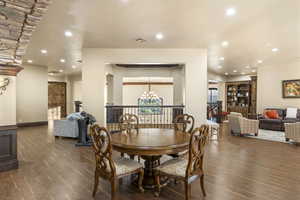 Dining area featuring recessed lighting, dark wood-type flooring, and a chandelier