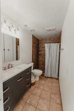 Primary bathroom with large vanity and tile shower.