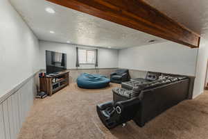 Large family room in daylight basement with fire place.