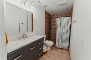 Primary bathroom with large vanity and tile shower.