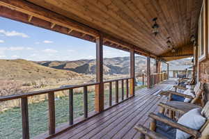 Wooden terrace featuring a mountain view
