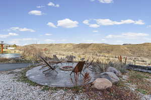 View of yard featuring a patio area, a fire pit, and a mountain view