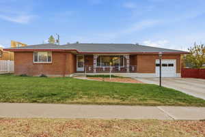 Ranch-style home with brick siding, a shingled roof, a garage, and concrete driveway
