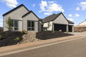 Single story home featuring a garage, driveway, stucco siding, and a tiled roof