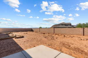 Fenced backyard with a patio