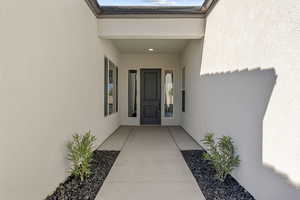 Entrance to property with stucco siding