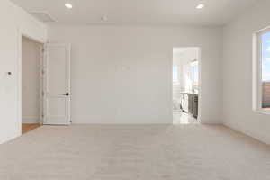 Spare room featuring recessed lighting and light colored carpet