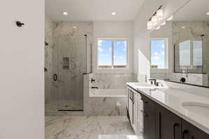 Full bathroom featuring double vanity, a garden tub, light marble finish floors, a marble finish shower, and recessed lighting