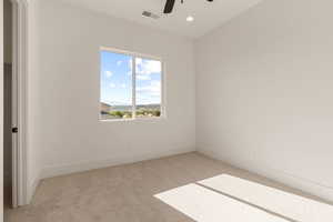 Unfurnished bedroom with light carpet, a ceiling fan, recessed lighting, and a mountain view