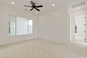 Empty room featuring light carpet, recessed lighting, and a ceiling fan