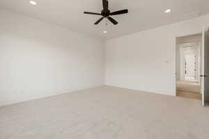 Unfurnished room featuring recessed lighting, light colored carpet, and a ceiling fan
