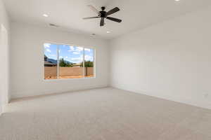Spare room with light carpet, recessed lighting, and a ceiling fan
