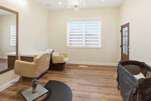 Living area featuring light wood-type flooring, a chandelier, and recessed lighting