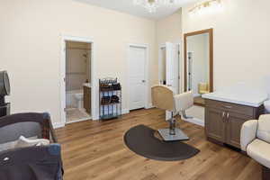 Living area featuring light wood-type flooring and baseboards