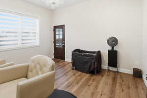 Living area with wood finished floors and a chandelier